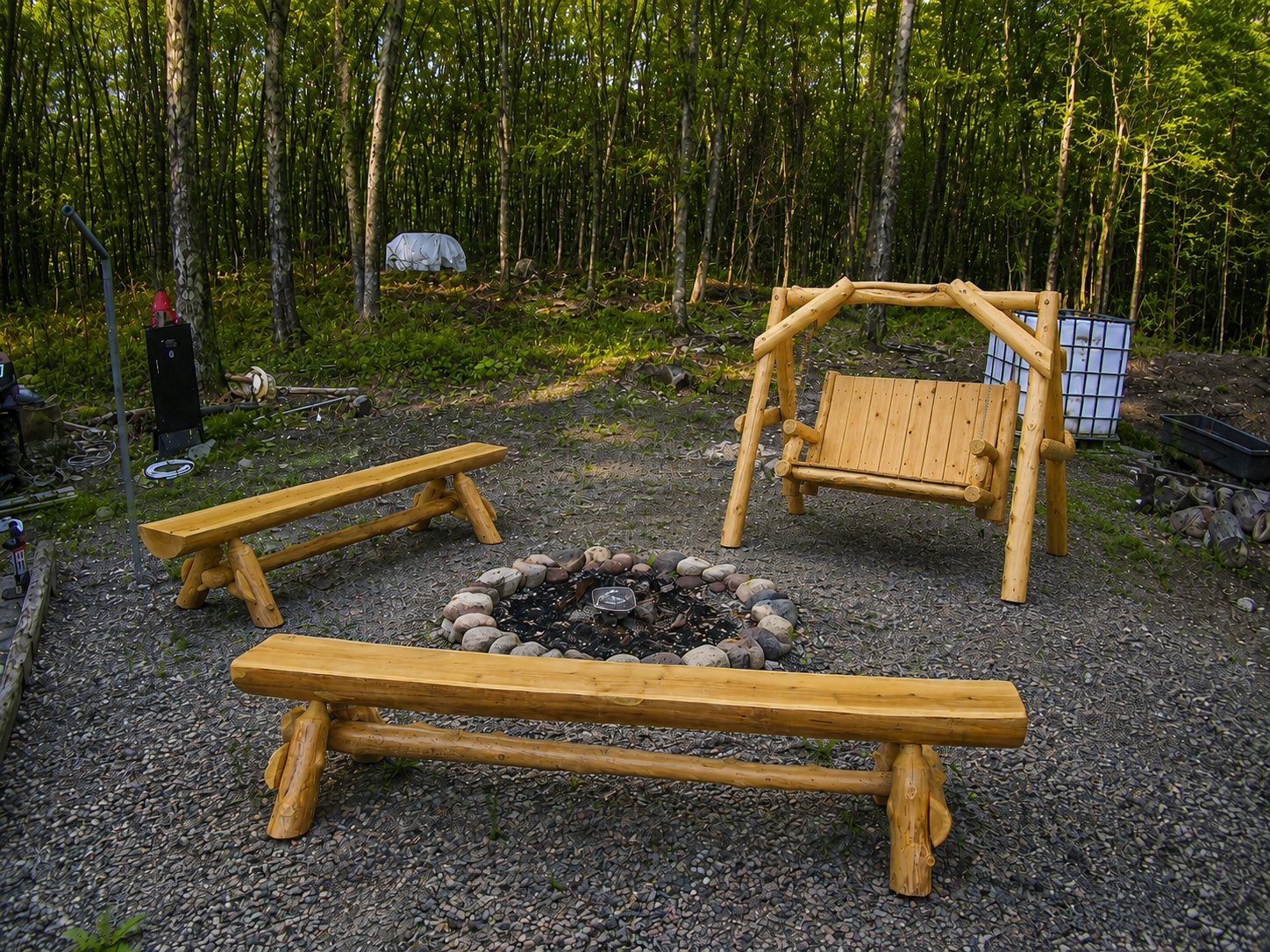 Outdoor firepit seating set with handcrafted benches and swing